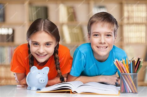 Premium Photo Smiling Happy Children Sitting By The Table During Lesson