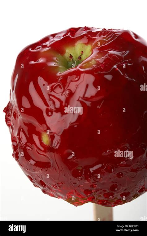 candy apple covered in dripping red candy traditionally eaten in ...