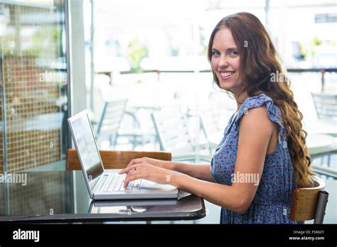 Pretty Brunette Using Her Laptop Stock Photo Alamy