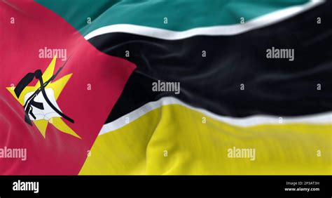 Detail Of The Mozambique Flag Waving Green Black And Yellow Stripes