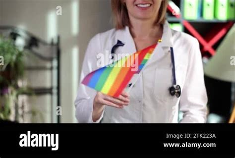 Doctor Holds LGBT Rainbow Flag In Clinic National Health System Concept LGBT Gay Bisexual And