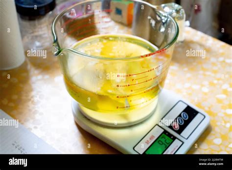 Hot Of Girl Wearing Latex Gloves Blending Oils Using Blender With A Small Glass Bottle Of