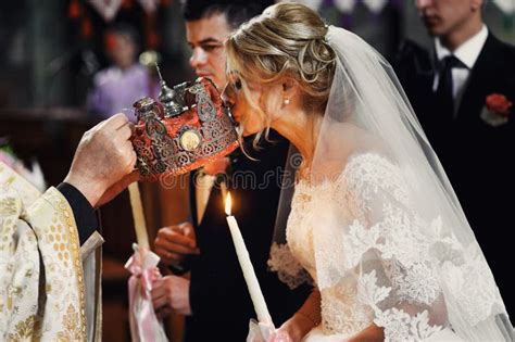 Beautiful Bride in White Dress Kissing Crown from a Priest at we Stock ...
