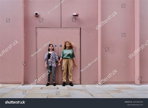 Happy Lesbian Couple Standing Front Pink Stock Photo