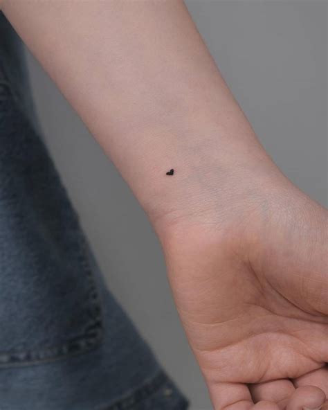 Tiny Minimalistic Heart Tattoo Placed On The Wrist