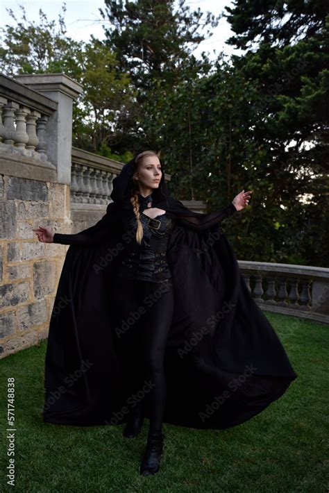 Portrait Of Beautiful Female Model With Blonde Plait Wearing Black Leather Catsuit And Flowing