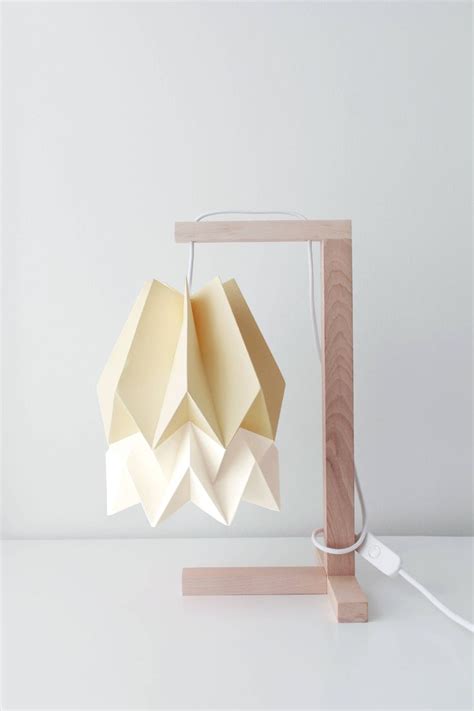 An Origami Lamp On A Wooden Stand