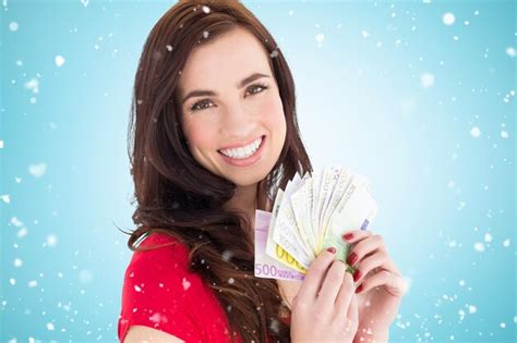 Premium Photo Happy Brunette Holding Her Cash Money Against Blue Vignette