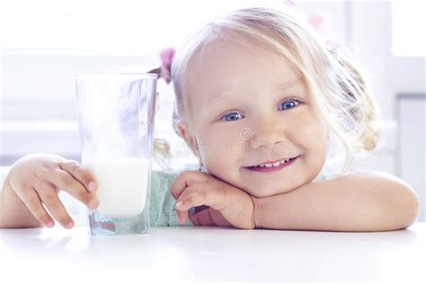 Blonde Girl Smiles And Drinks Milk Stock Photo Image Of Drinking Holiday