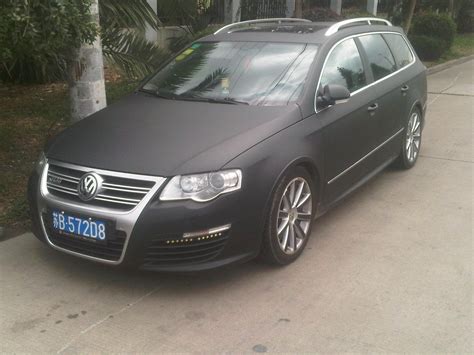 A Black Car Parked On The Side Of The Road