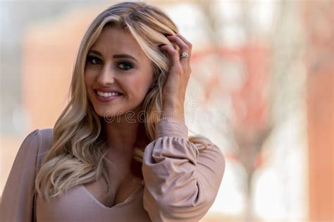 Blonde Beauty Strolls Through Town Savoring The Crisp Air And Colors Of A Perfect Autumn Day