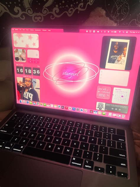 An Open Laptop Computer Sitting On Top Of A Wooden Table Next To A