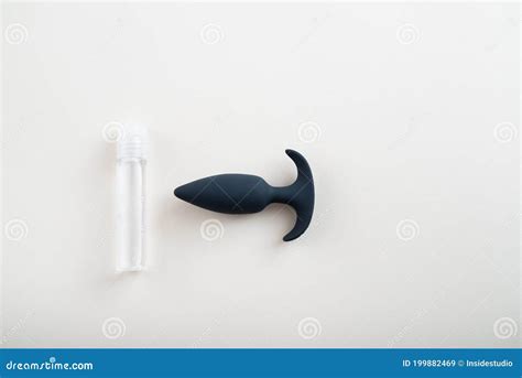 Top View Of Black Plug And Bottle Of Lubricant On White Background Safe Anal Sex Concept Stock