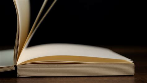 4k Slow Motion Of Open Book With Blank Page On Black Background