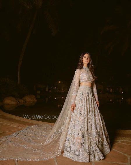 Photo Of Stunning Nude On White Lehenga With A Train Style Dupatta And