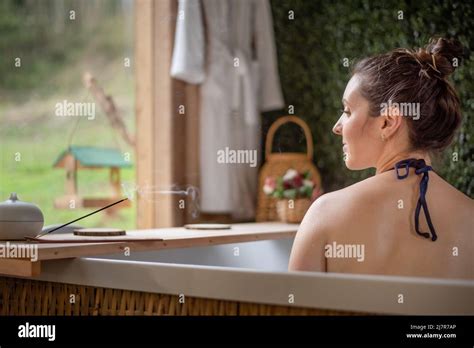 Woman In Hot Tub Enjoying The Scent Of Incense Stock Photo Alamy