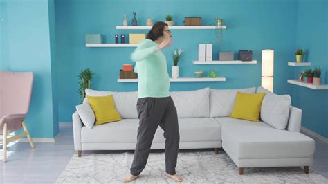 Funny man hurts his back while exercising at home. 33057645 Stock Video