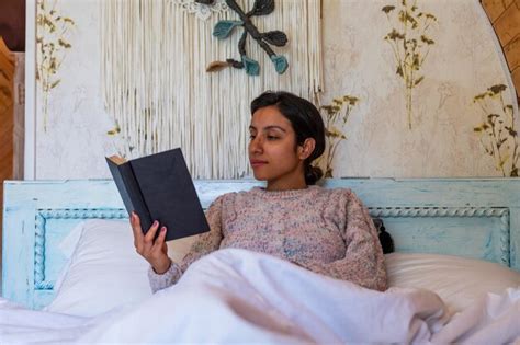 Premium Photo Cozy Morning Bliss Latina Woman Enjoying A Relaxing Read In Bed