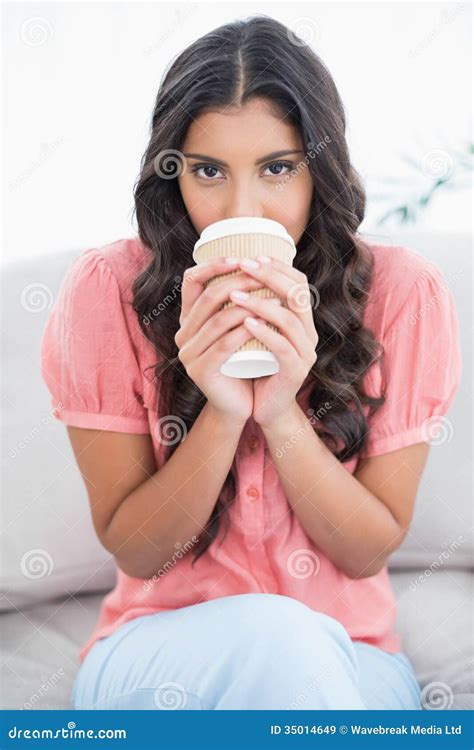 Calm Cute Brunette Sitting On Couch Drinking From Disposable Cup Stock Image Image Of Women