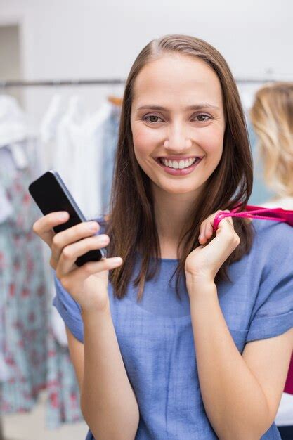 Premium Photo Pretty Brunette Holding A Smartphone