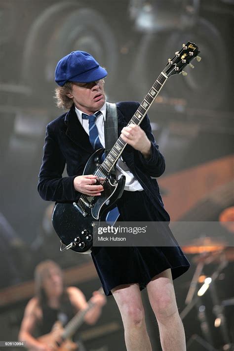 angus young  acdc performs  stage playing  gibson sg guitar