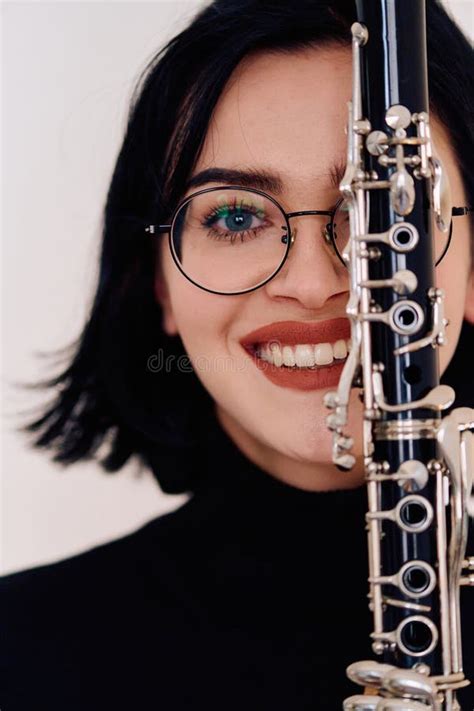 Graceful Brunette Musician Posing With Clarinet On White Background Stock Photo Image Of