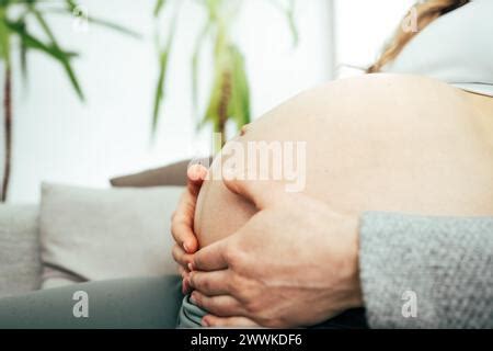 Description Close Up Of Naked Round Belly Held By Hands Of Pregnant Woman In Underwear Last
