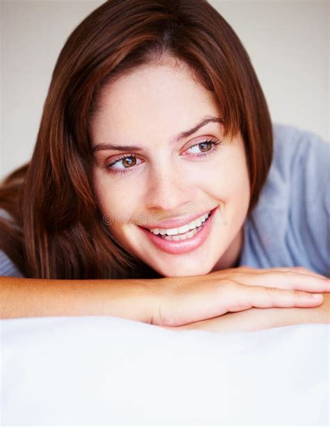 Smiling Cute Female Brunette Lying On Bed Closeup Portrait Of A Cute Smiling Female Brunette