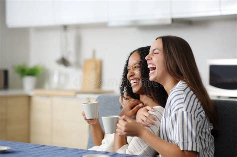 Happy Interracial Lesbian Couple Laughing In The Kitchen Stock Image Image Of Flirt Home
