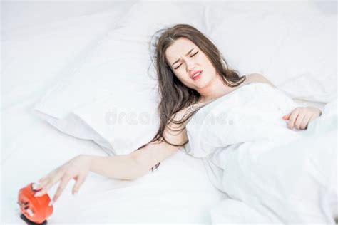 The Brunette Lies Wakes Up From The Sound Of The Alarm Clock Loud