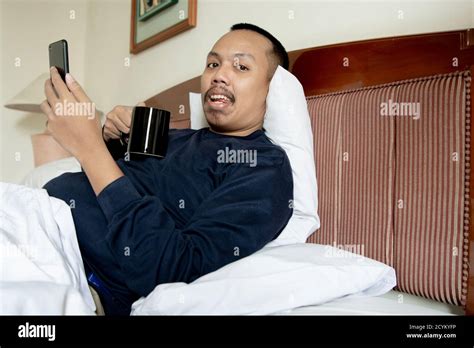 Side View Of Fat Man Has A Mustache Happy With A Smartphone And Enjoy