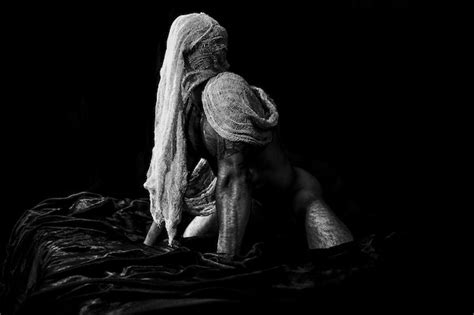 Premium Photo Naked Mature Man Kneeling On Bed Against Black Background