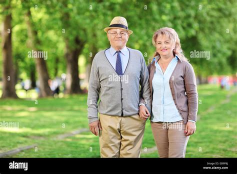 Happy Mature Couple Posing In A Park Stock Photo Alamy