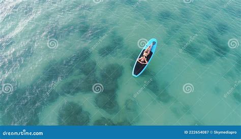 Attractive Woman In Bikini Is Sunbathing On A Surfboard Aerial View Stock Image Image Of