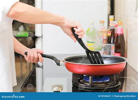 Woman Holding a Pan in the Hand Cooking Omelette in Kitchen. Stock ...