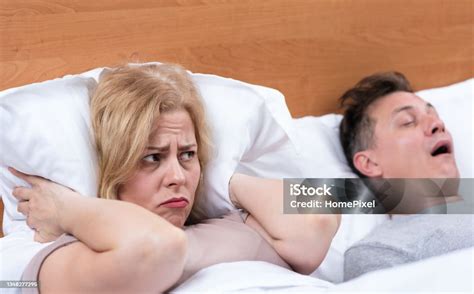 Couple In Bed Man Sleeping And Snoring With Open Mouth Disgruntled