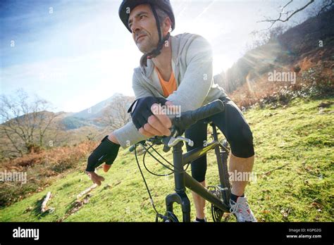Mature Man Riding Bike In The Mountain Stock Photo Alamy
