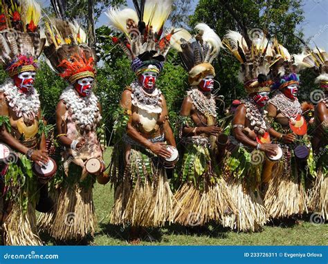 Dancing Papuan Women In Traditional Clothes And Face Paintings