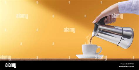 Woman Having A Coffee Break She Is Pouring Hot Coffee In A Cup Stock Photo Alamy