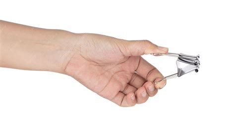 premium photo hand holding black paper clip isolated  white background