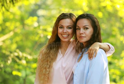 Mature Mother And Adult Daughter Hugging In The Park On A Summer Day Stock Photo Image Of