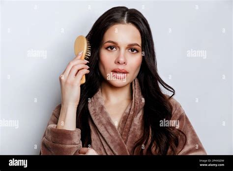 Brunette Woman Brushing Beautiful Healthy Long Hair With Brush Stock Photo Alamy