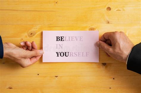 Believe In Yourself Sign Fading Into A Be You Message Written On Pink