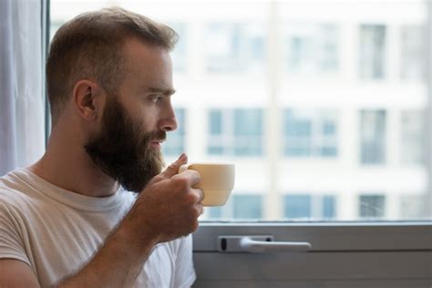 Free Photo Close Up Of Pensive Hipster Man Drinking Coffee From Cup