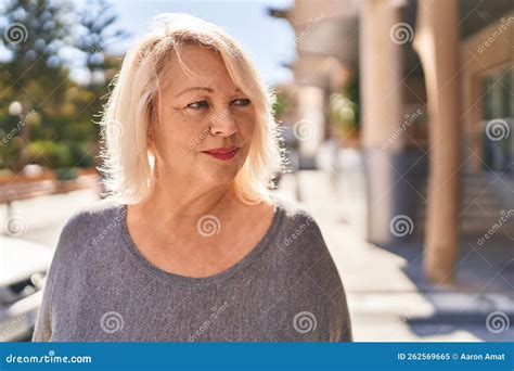 Middle Age Blonde Woman With Relaxed Expression Standing At Street Stock Image Image Of Casual