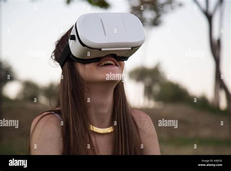 Smiling Brunette Having Fun While Using Glasses Of Virtual Reality In Park Stock Photo Alamy