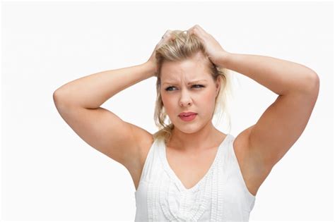 Premium Photo Serious Blonde Woman Placing Her Hands On Her Head