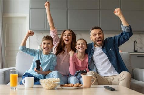 Premium Photo | Family celebrates a win while playing video game