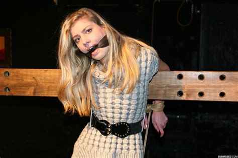 Une jolie blonde se débat contre un bâillon et des cordes alors qu elle est encore habillée