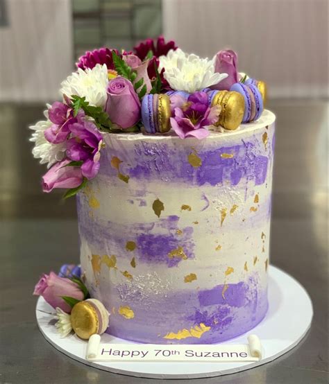 Purple And Gold Themed Cake With Flowers And Macarons Unusual